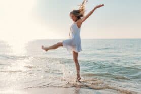 Happy woman splashing in the sea